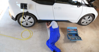 Mechanic repairing an electric driven car in garage